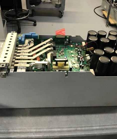 An engineer repairing a VFD drive circuit board